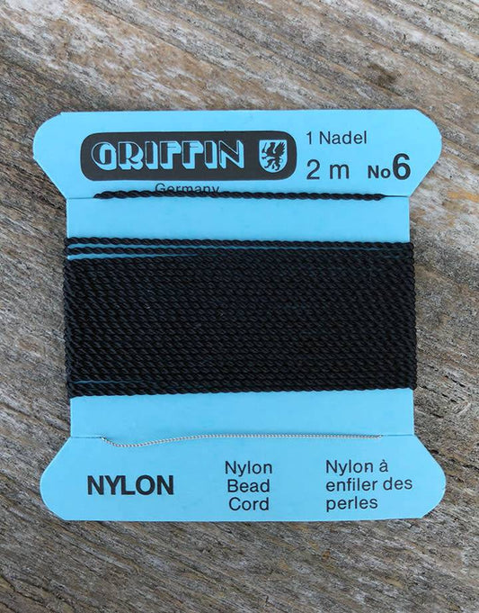 38.0706 = Black Nylon Beading Cord #6 on Card with Needle