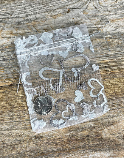 DBX1293HW = Organza Drawstring Pouches White with Silver Hearts 3''x4'' (Pkg/10)