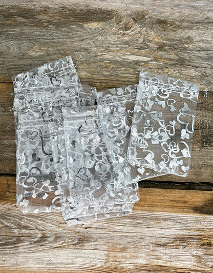 DBX1294HW = Organza Drawstring Pouches White with Silver Hearts 4''x5'' (Pkg/10)