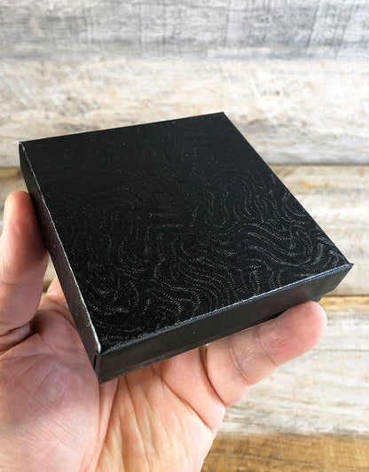 DBX2833B = BOXES - COTTON FILLED BLACK SWIRL  3-1/2'' x 3-1/2'' x 1''  CASE 100