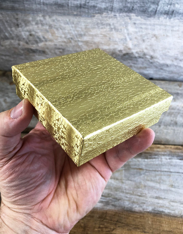 DBX2833G = BOXES - COTTON FILLED GOLD FOIL  3-1/2'' x 3-1/2'' x 1''  CASE 100