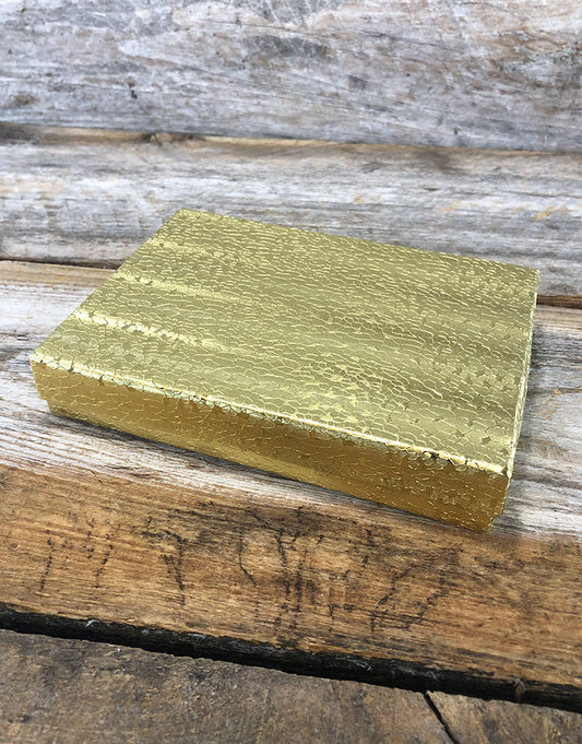 DBX2853G = BOXES - COTTON FILLED GOLD FOIL  5-3/8'' x 3-7/8'' x 1''  CASE 100