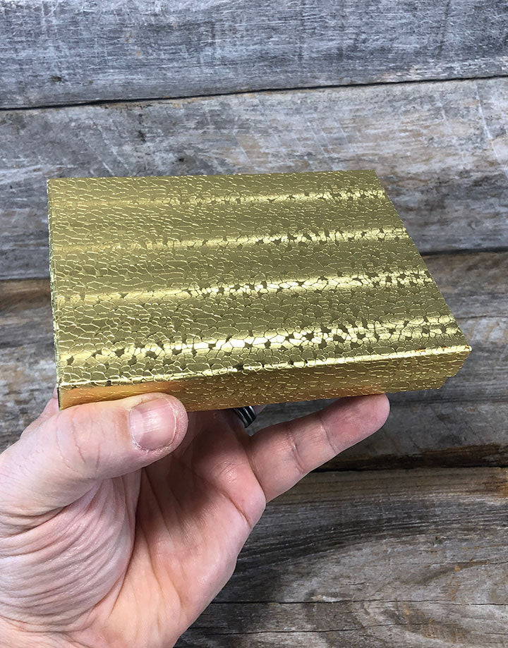 DBX2853G = BOXES - COTTON FILLED GOLD FOIL  5-3/8'' x 3-7/8'' x 1''  CASE 100