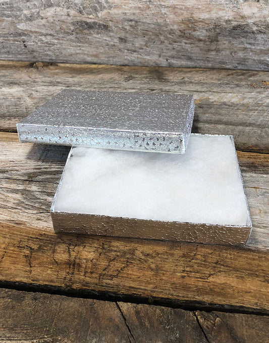 DBX2853S = BOXES - COTTON FILLED SILVER FOIL  5-3/8'' x 3-7/8'' x 1''  CASE 100