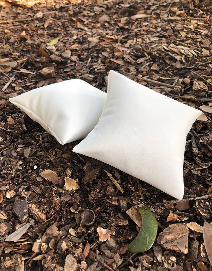 DIS6120 = White Leatherette Pillow for Watches or Bracelets 4''x4'' (Pkg of 5)
